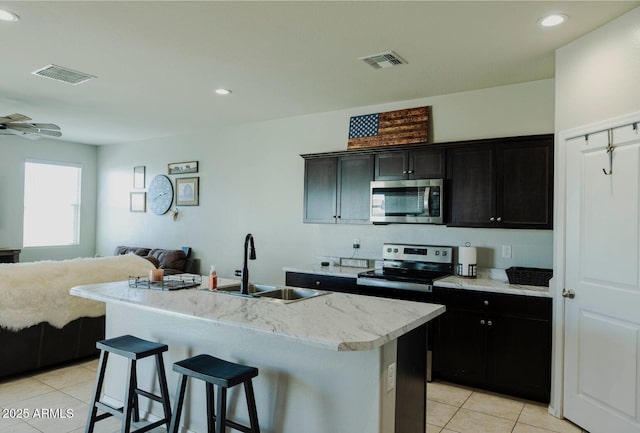 kitchen featuring open floor plan, visible vents, appliances with stainless steel finishes, and a sink