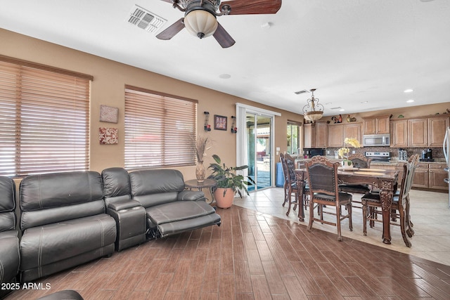 11965 W Monte Vista Rd, Avondale, AZ 85392 - living room featuring ceiling fan, light wood-type flooring, a chandelier, and recessed lighting