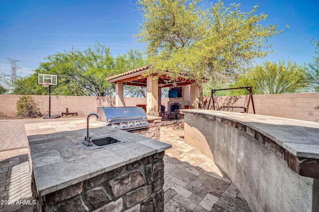 11965 W Monte Vista Rd, Avondale, AZ 85392 - fenced backyard featuring an outdoor stone fireplace, exterior kitchen, and a patio area