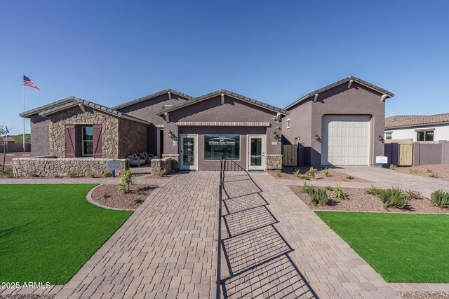 43712 N Acadia Way, New River, AZ 85087 - single story home with concrete driveway, stone siding, stucco siding, and an attached garage
