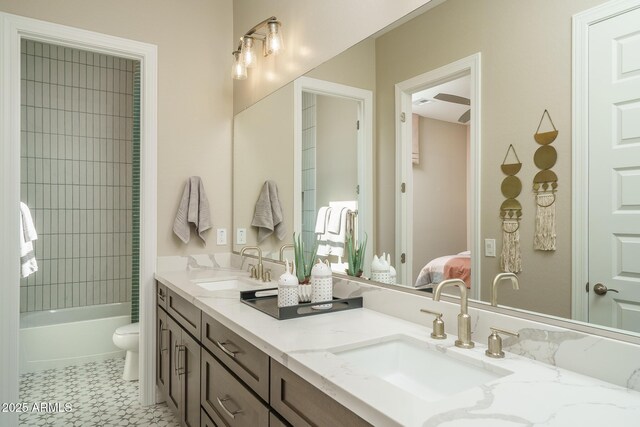 43712 N Acadia Way, New River, AZ 85087 - ensuite bathroom with double vanity, toilet, tile patterned floors, and shower / washtub combination