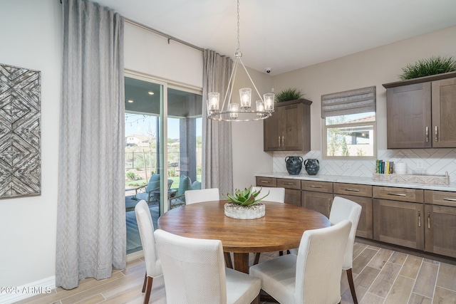 43712 N Acadia Way, New River, AZ 85087 - dining area featuring wood finish floors and a chandelier