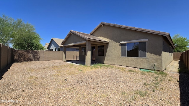 23853 W Hammond Ln, Buckeye, AZ 85326 - back of property featuring stucco siding, a fenced backyard, and a patio area