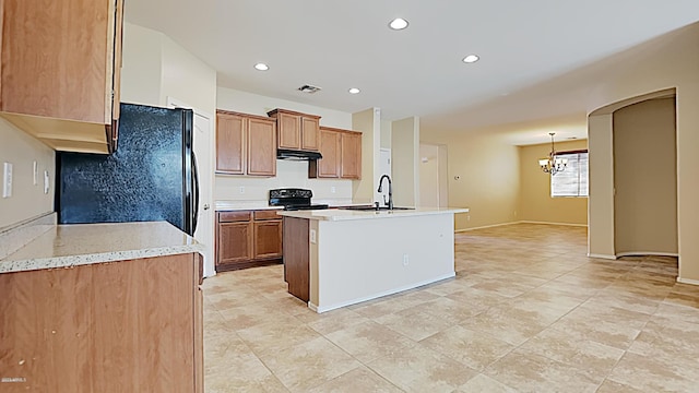 23853 W Hammond Ln, Buckeye, AZ 85326 - kitchen with a chandelier, black appliances, under cabinet range hood, recessed lighting, and light countertops