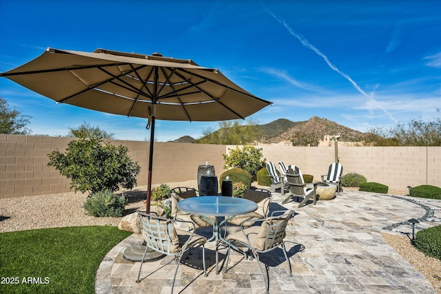 view of patio / terrace featuring a fenced backyard and a mountain view