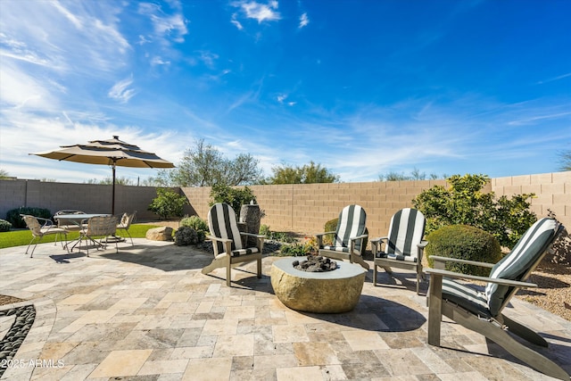 view of patio / terrace with an outdoor fire pit, a fenced backyard, and outdoor dining area