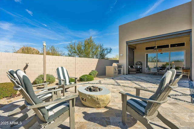 view of patio with a fire pit and fence