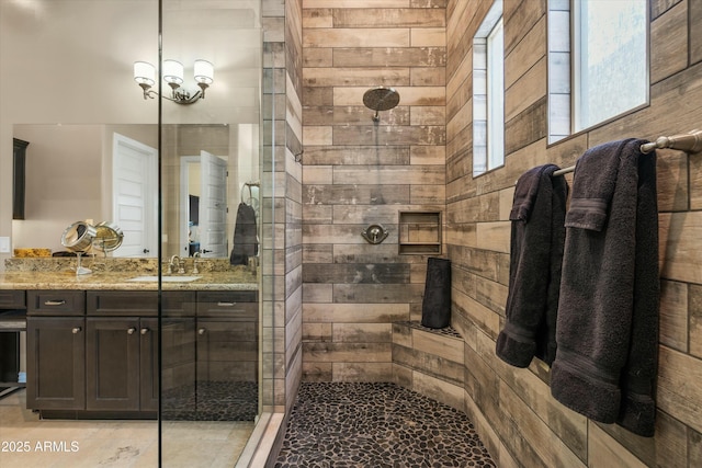 full bathroom with tiled shower and vanity