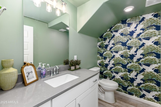 bathroom featuring vanity, hardwood / wood-style floors, and toilet