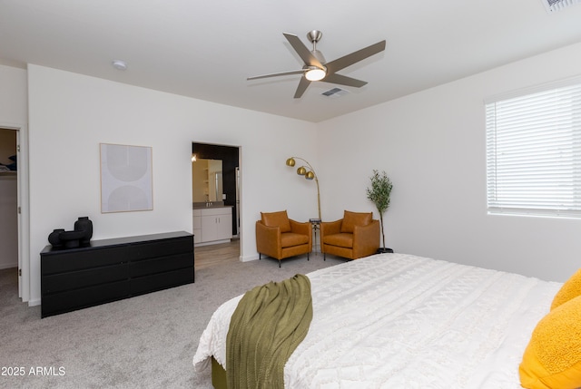 bedroom with ensuite bathroom, a spacious closet, light carpet, and ceiling fan