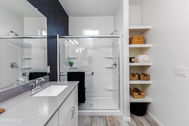 bathroom featuring an enclosed shower, hardwood / wood-style floors, and vanity