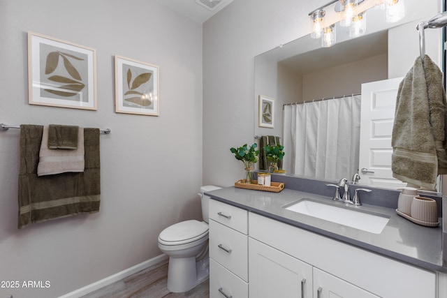 bathroom with vanity, wood-type flooring, and toilet