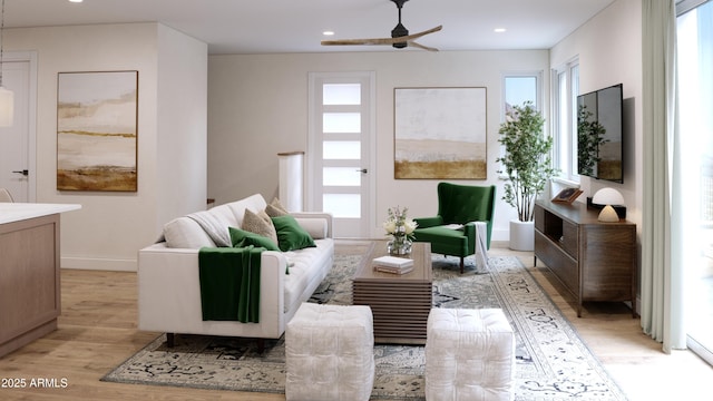 living area with ceiling fan and light wood-type flooring