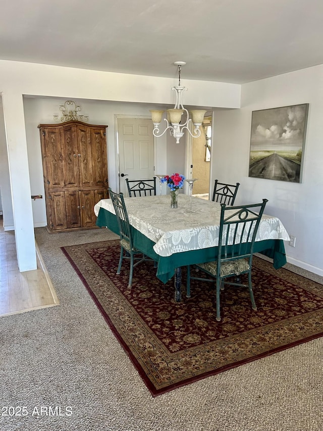 dining area with a notable chandelier and baseboards