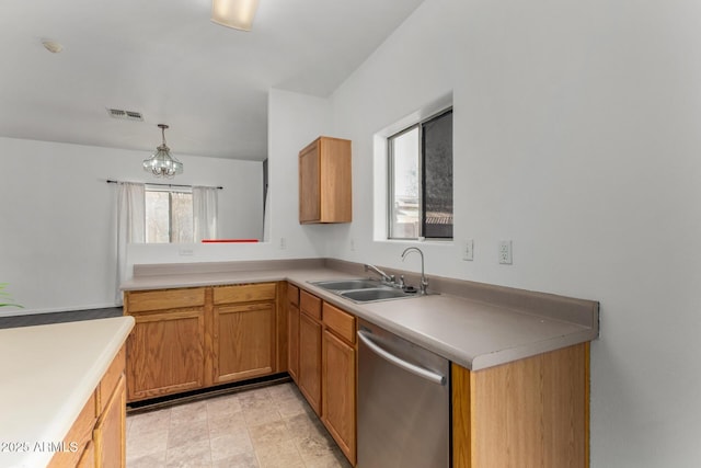 kitchen featuring light countertops, visible vents, dishwasher, a sink, and an inviting chandelier