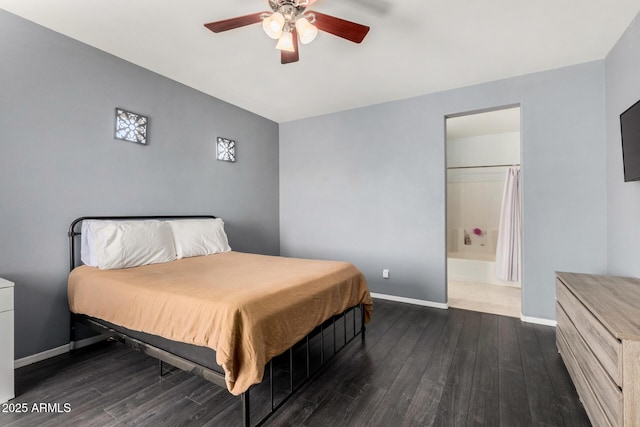 bedroom featuring connected bathroom, baseboards, wood finished floors, and a ceiling fan