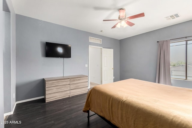 bedroom with baseboards, dark wood-style floors, visible vents, and ceiling fan