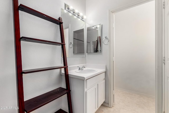 bathroom with vanity and baseboards