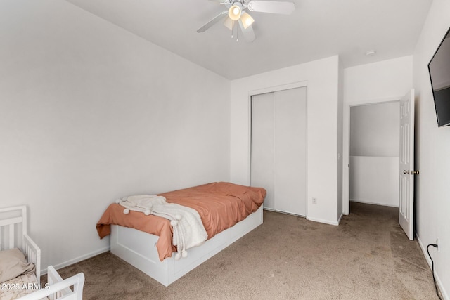 carpeted bedroom with a closet and ceiling fan