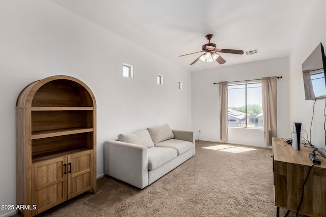 living room with carpet floors, ceiling fan, and visible vents