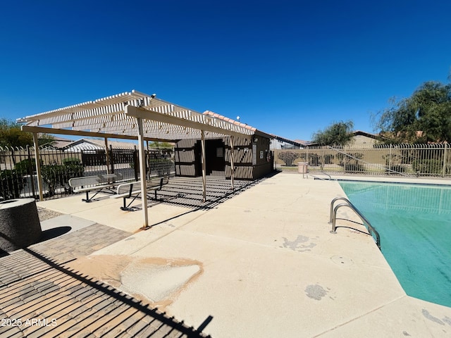 community pool with fence, a pergola, and a patio area