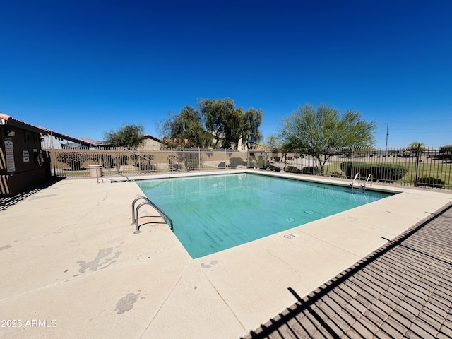 pool featuring fence and a patio