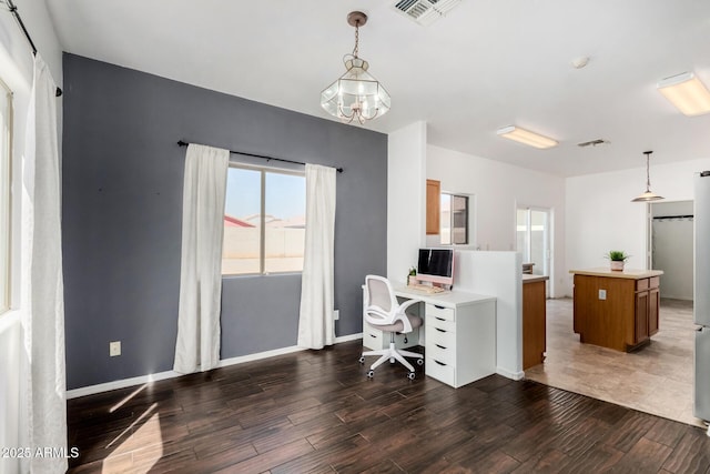 office space featuring visible vents, a chandelier, and wood finished floors