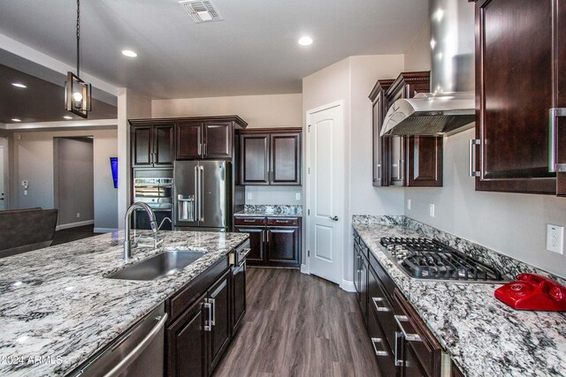 kitchen featuring pendant lighting, sink, ventilation hood, stainless steel appliances, and dark hardwood / wood-style floors