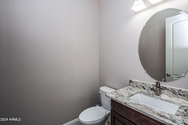 bathroom with toilet and vanity