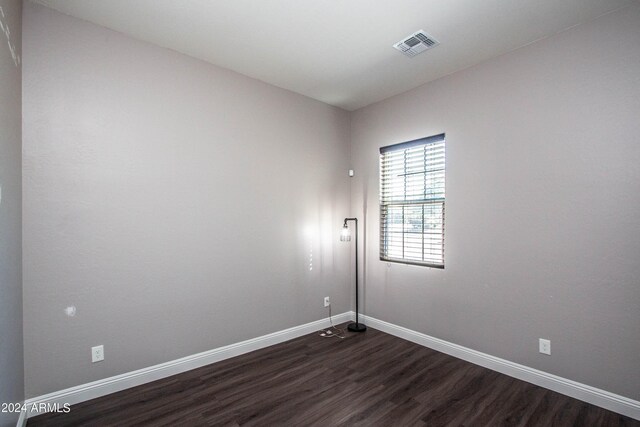 unfurnished room featuring dark hardwood / wood-style flooring