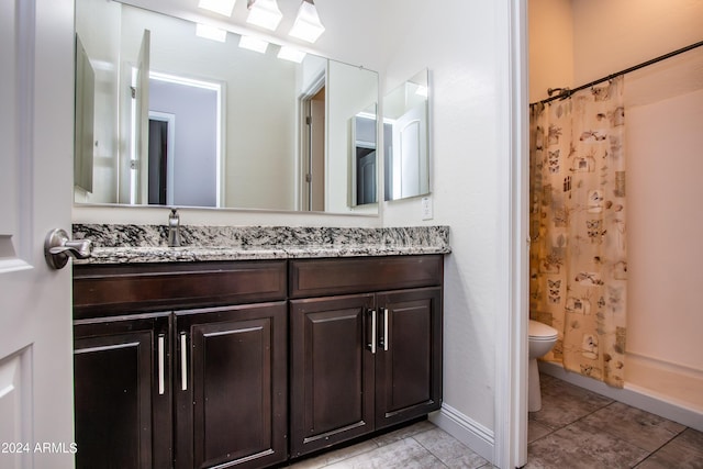 bathroom with tile patterned floors, a shower with shower curtain, toilet, vanity, and baseboards