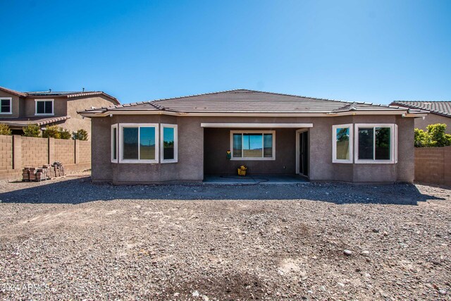 rear view of property featuring a patio