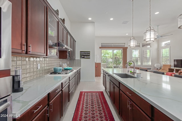 kitchen featuring hanging light fixtures, sink, a wealth of natural light, and stainless steel appliances