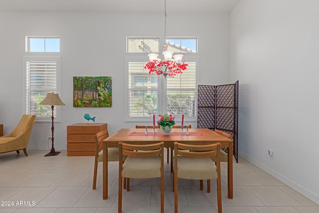 dining area featuring a chandelier and light tile patterned floors