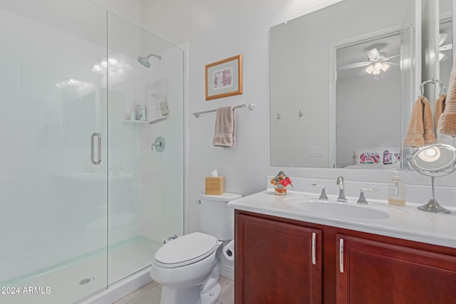 bathroom featuring ceiling fan, toilet, vanity, and walk in shower