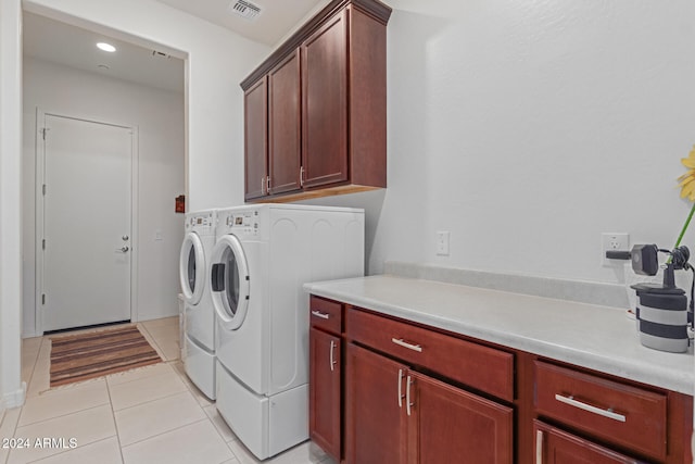 washroom featuring light tile patterned flooring, cabinets, and separate washer and dryer