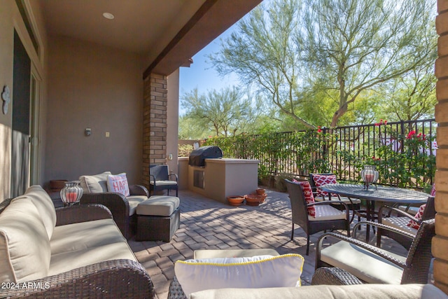 view of patio featuring an outdoor living space, a grill, and an outdoor kitchen