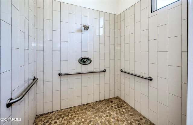 bathroom with tiled shower