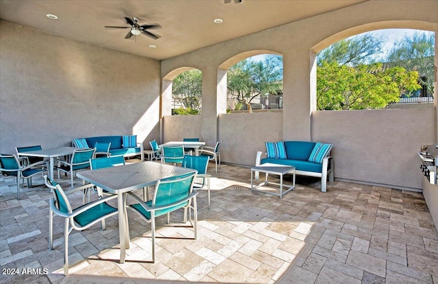 view of patio / terrace with ceiling fan and an outdoor living space