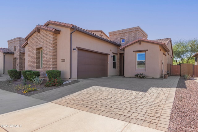 mediterranean / spanish house featuring a garage