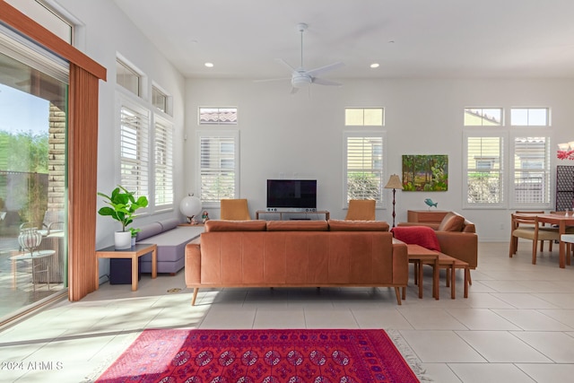 tiled living room with ceiling fan