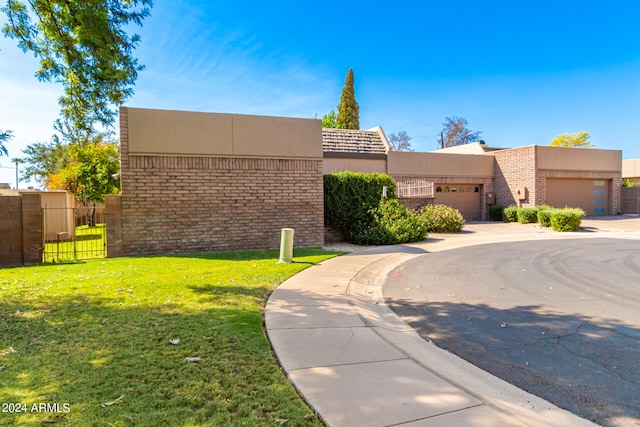 view of front of property with a garage and a front yard