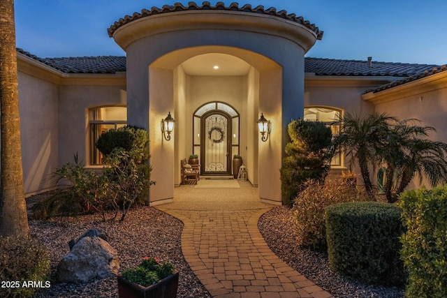 view of exterior entry at dusk