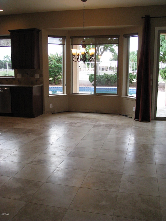 unfurnished dining area with a notable chandelier and a wealth of natural light