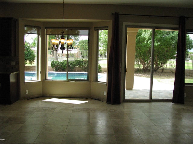 unfurnished dining area with a chandelier