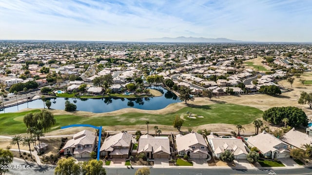 birds eye view of property featuring view of golf course, a residential view, and a water and mountain view