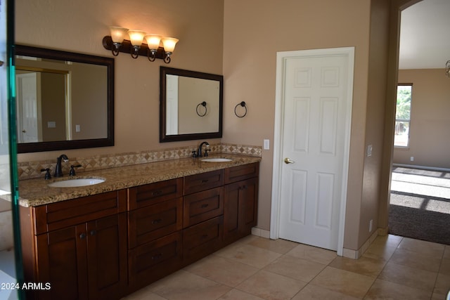 full bathroom featuring tile patterned flooring, a sink, and double vanity