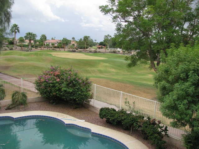 view of pool featuring a yard