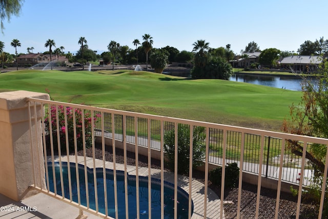 view of home's community with a water view, fence, and golf course view