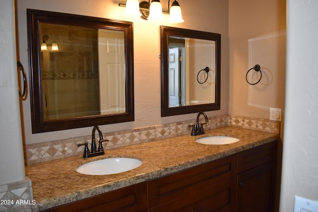 bathroom with a sink and double vanity